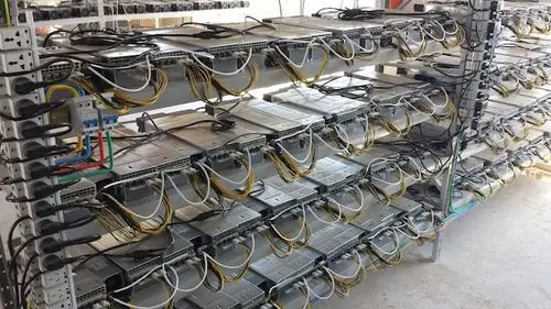 A large-scale mining farm with rows of ASIC miners.